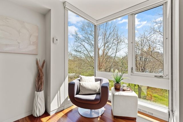 a living room with a large window and a glass door