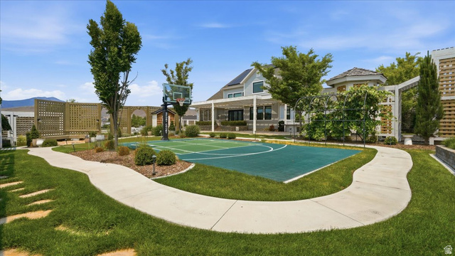 2038 East Ranch Road Eagle Mountain, UT 84005 - Photo 49 of 66 Outdoor sports court with painted game lines, surrounded by manicured lawn and mature landscaping