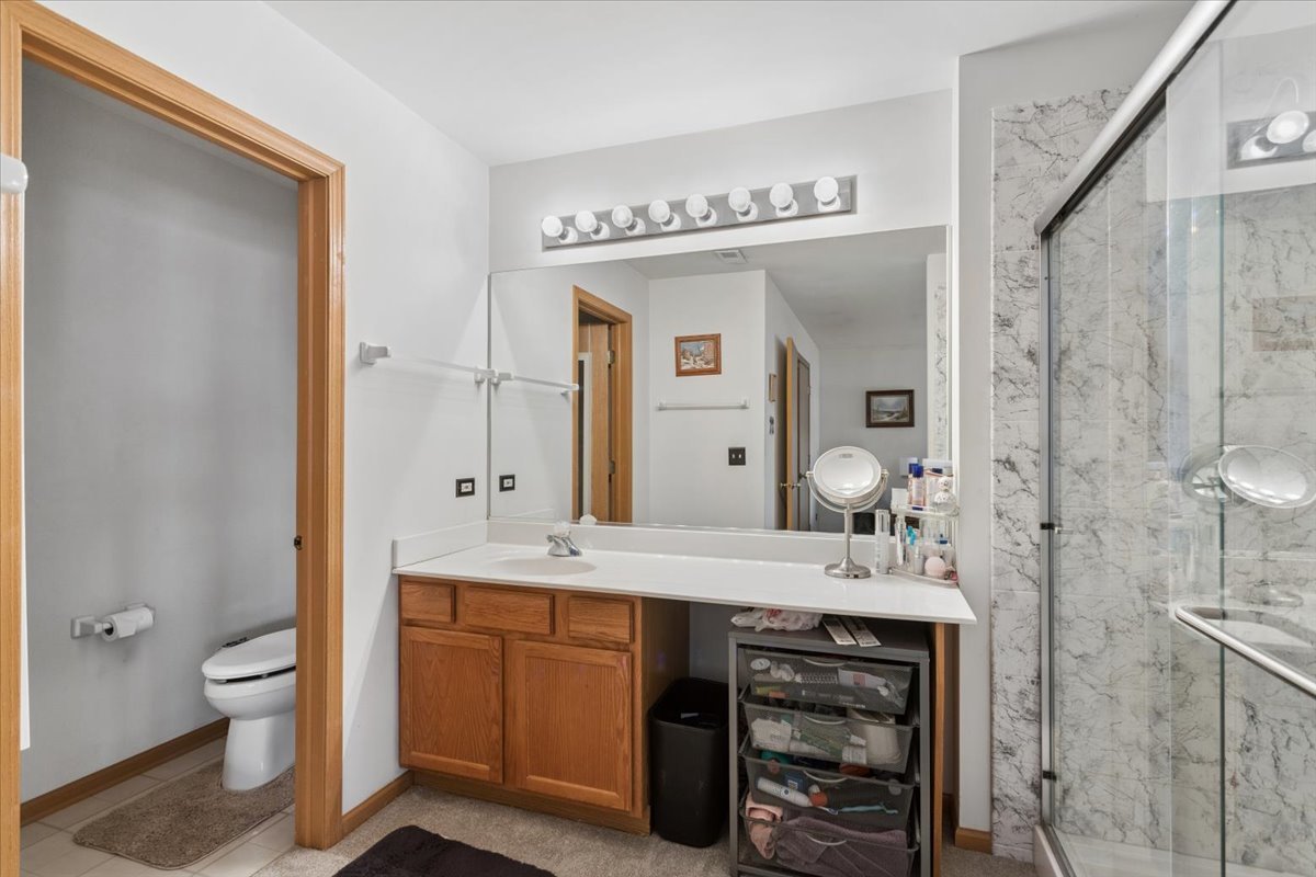 14902 West Victoria Crossing Lockport, IL 60441 - Photo 12 of 23 a spacious bathroom with a sink a toilet and a large mirror
