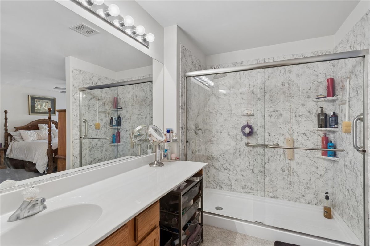 14902 West Victoria Crossing Lockport, IL 60441 - Photo 13 of 23 a bathroom with a granite countertop sink a mirror and shower