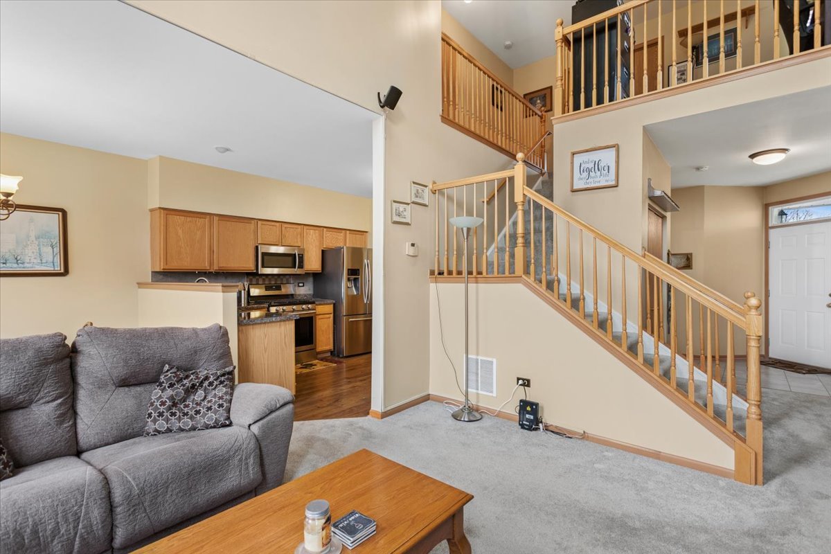 14902 West Victoria Crossing Lockport, IL 60441 - Photo 19 of 23 a living room with furniture cabinets and stairs