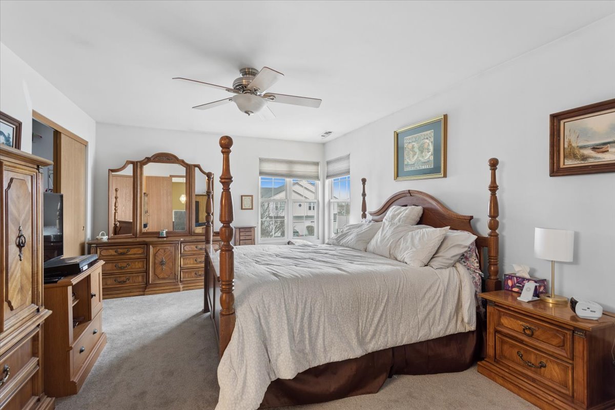 14902 West Victoria Crossing Lockport, IL 60441 - Photo 23 of 23 a bedroom with a bed and a chandelier