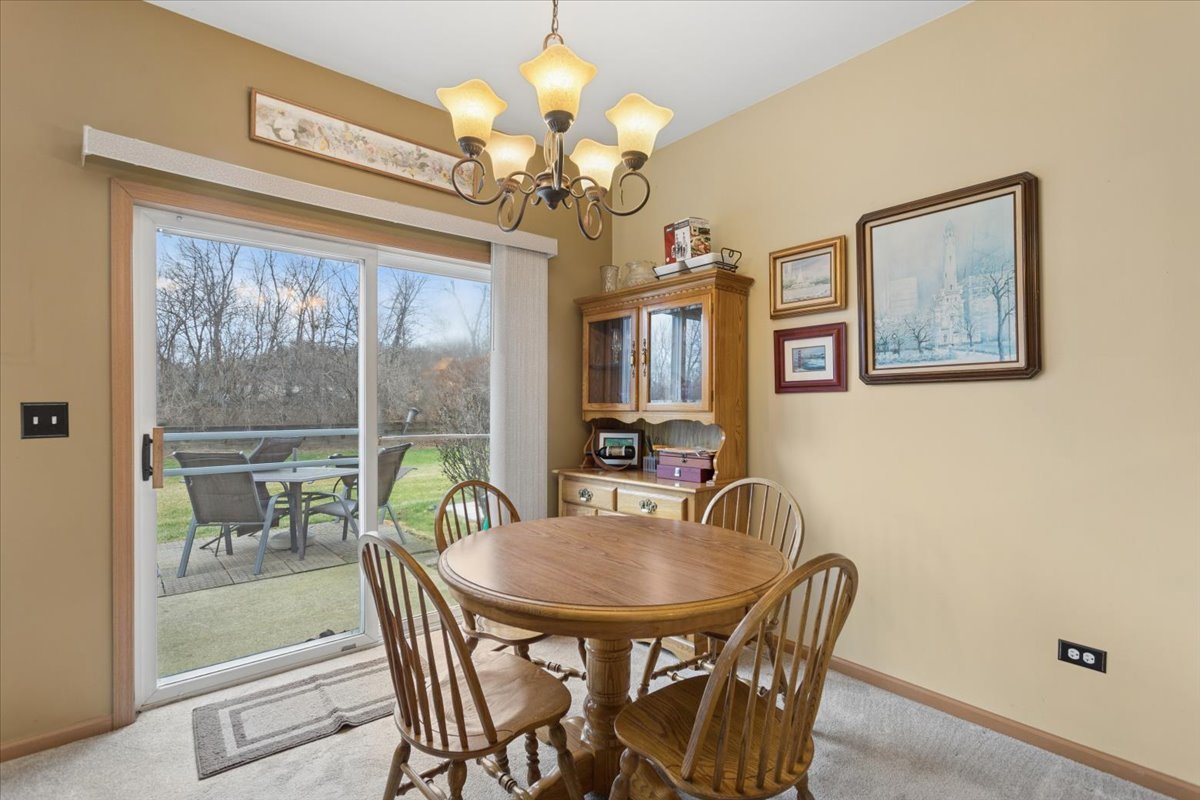 14902 West Victoria Crossing Lockport, IL 60441 - Photo 4 of 23 a dining room with furniture a livingroom and chandelier