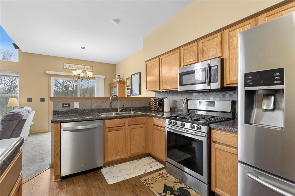 14902 West Victoria Crossing Lockport, IL 60441 - Photo 5 of 23 a kitchen with stainless steel appliances a stove a sink and a microwave
