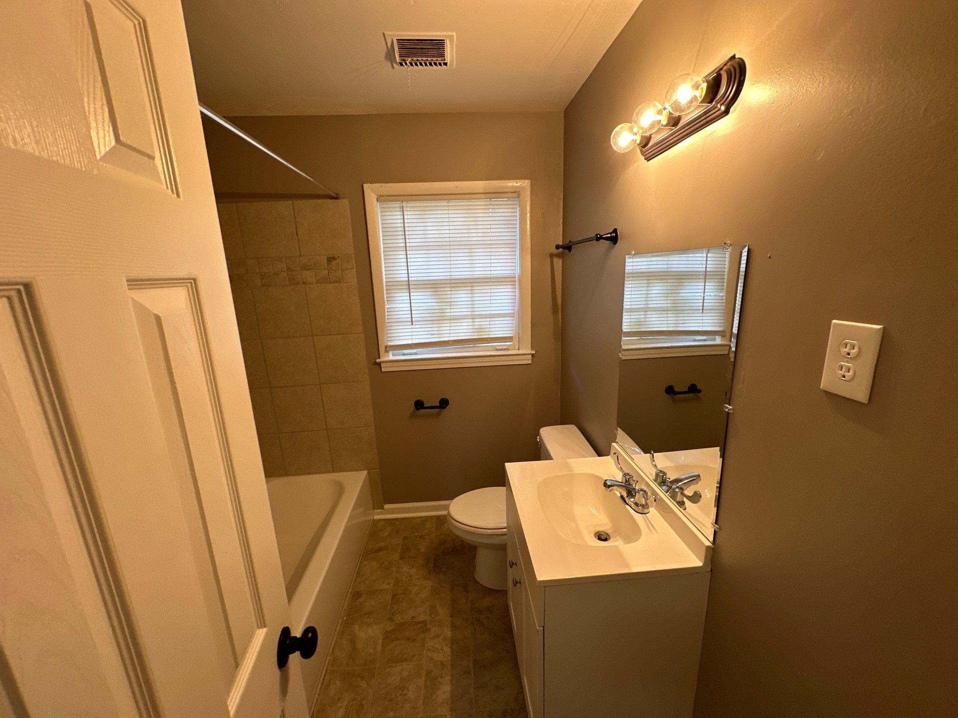 10 West Mitchell Road Memphis, TN 38109 - Photo 3 of 11 Bathroom featuring vanity, tile patterned flooring, visible vents, toilet, and shower / bathing tub combination