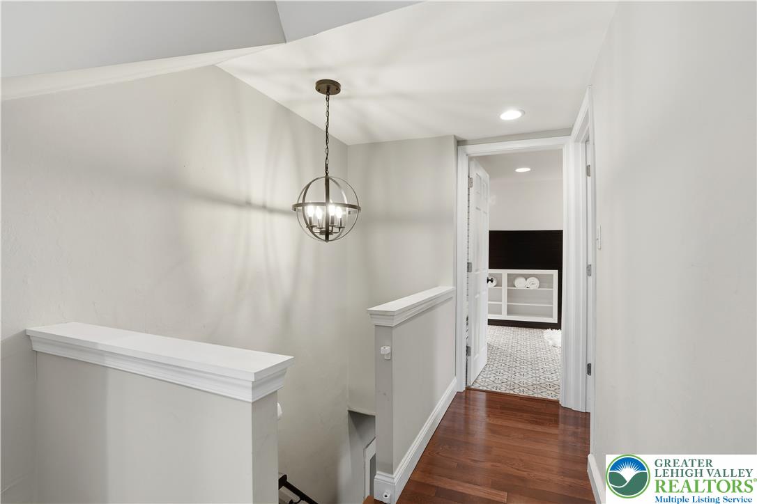 2014 Linden Street Bethlehem, PA 18017 - Photo 48 of 85 A well-lit landing features gleaming hardwood flooring and a stylish spherical chandelier.