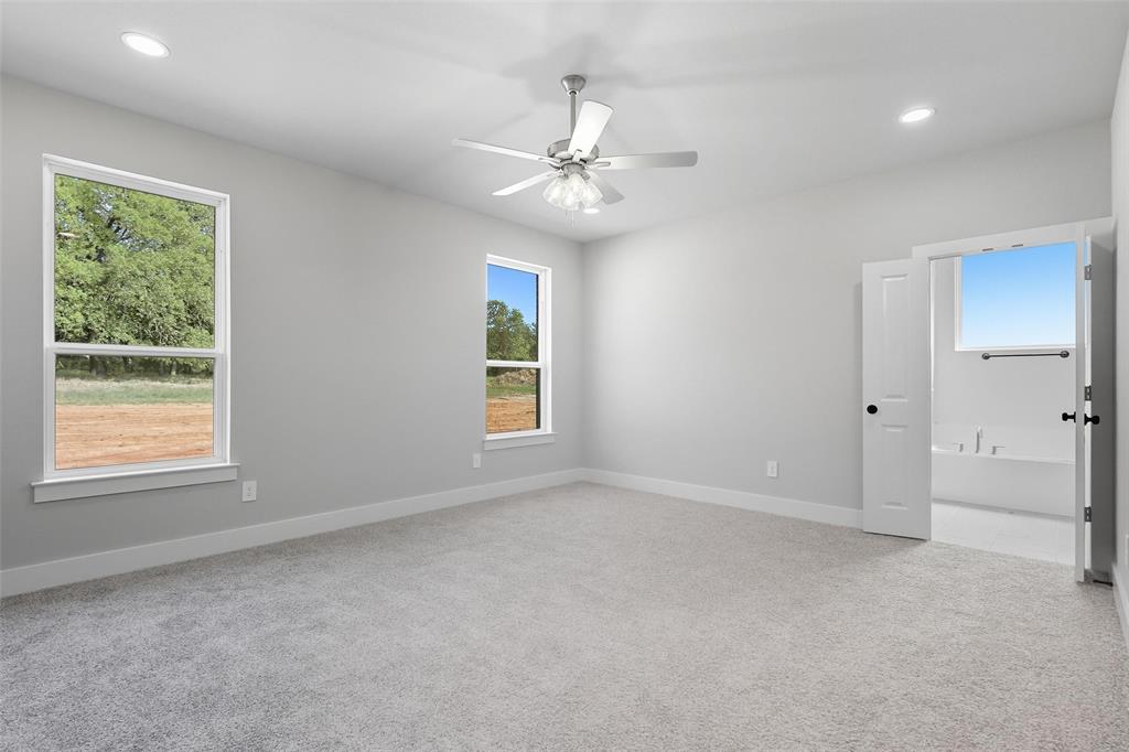 1005 Ronnie Court Springtown, TX 76082 - Photo 16 of 27 Spare room featuring light carpet, recessed lighting, and ceiling fan