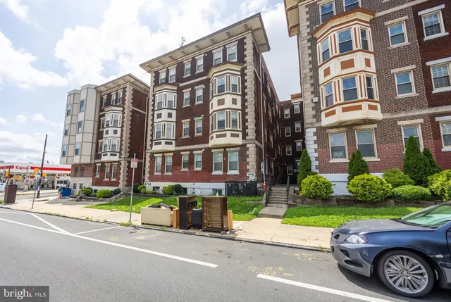 a car parked in front of a brick building