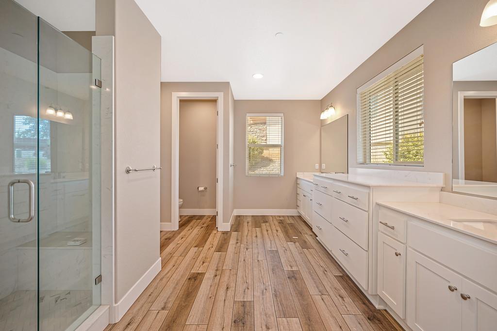 504 Chase Court Colfax, CA 95713 - Photo 54 of 94 a spacious bathroom with a double vanity sink a large mirror and shower