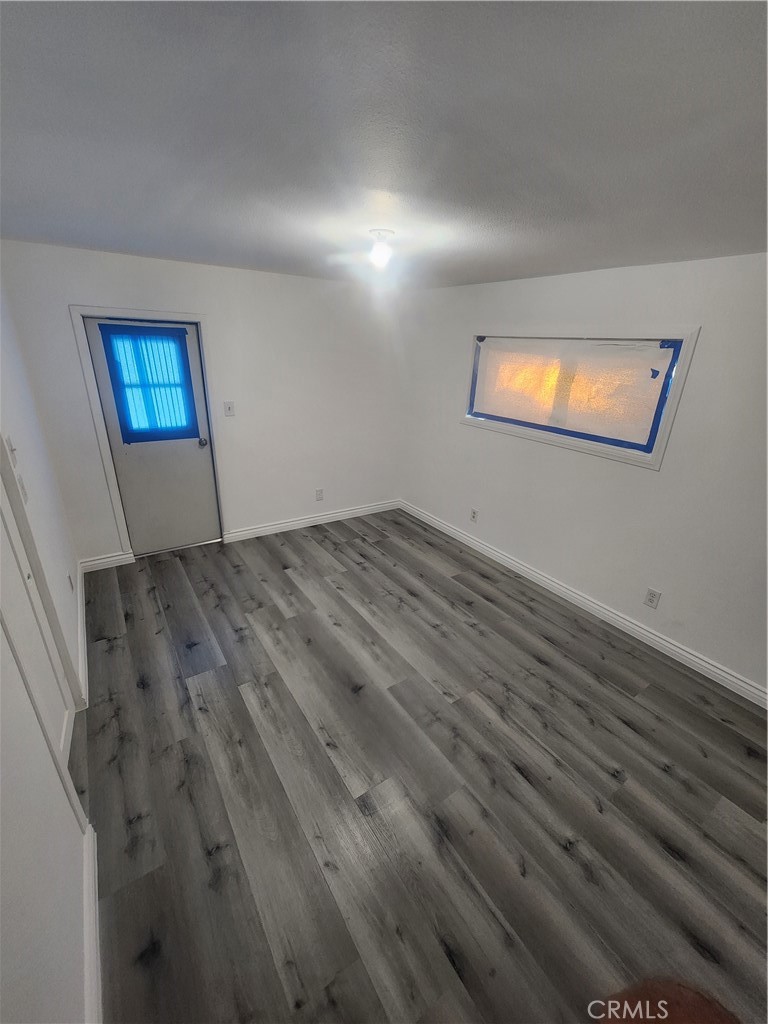 3319 Avalon Street, Unit 78 Riverside, CA 92509 - Photo 16 of 37 an empty room with wooden floor and windows
