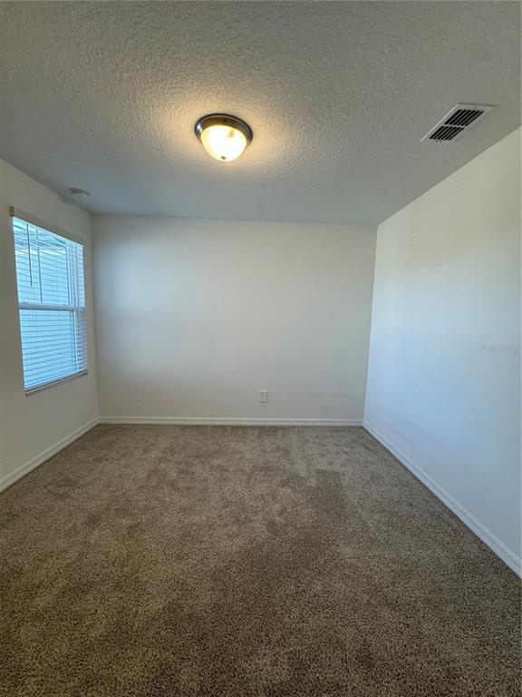 4346 Restful Fallow Cove St. Cloud, FL 34772 - Photo 12 of 20 an empty room with a empty space and windows