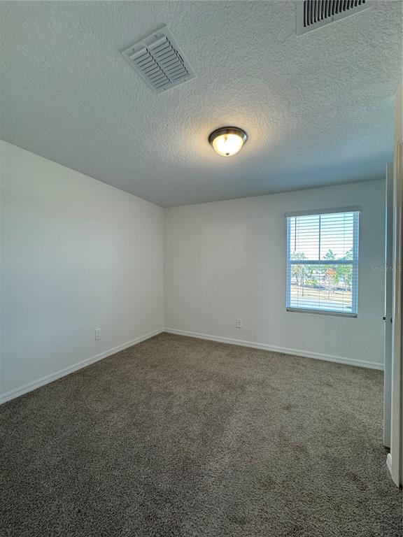 4346 Restful Fallow Cove St. Cloud, FL 34772 - Photo 14 of 20 an empty room with a empty space and windows