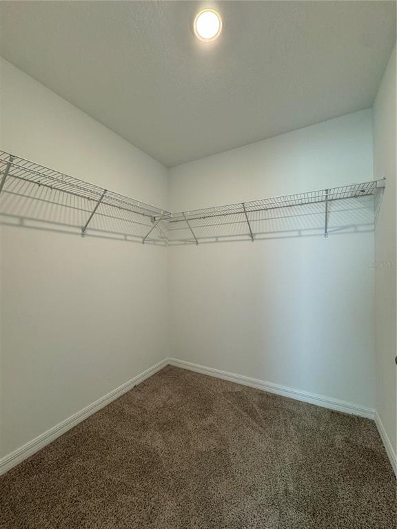4346 Restful Fallow Cove St. Cloud, FL 34772 - Photo 15 of 20 a view of a room with racks on the wall