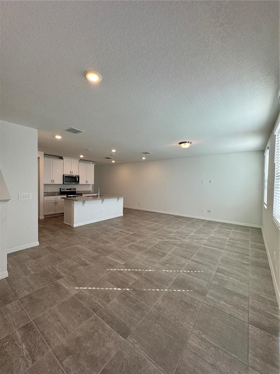 4346 Restful Fallow Cove St. Cloud, FL 34772 - Photo 4 of 20 a view of kitchen with kitchen island white cabinets and appliances