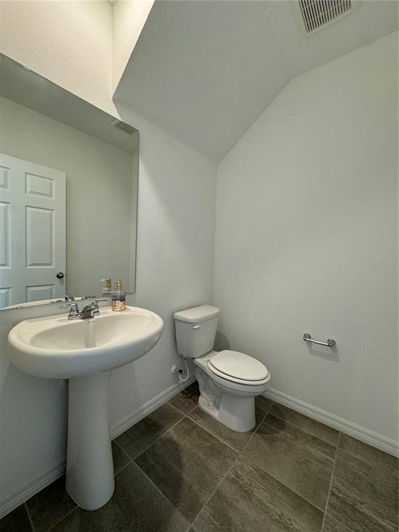 4346 Restful Fallow Cove St. Cloud, FL 34772 - Photo 6 of 20 a bathroom with a sink toilet and mirror