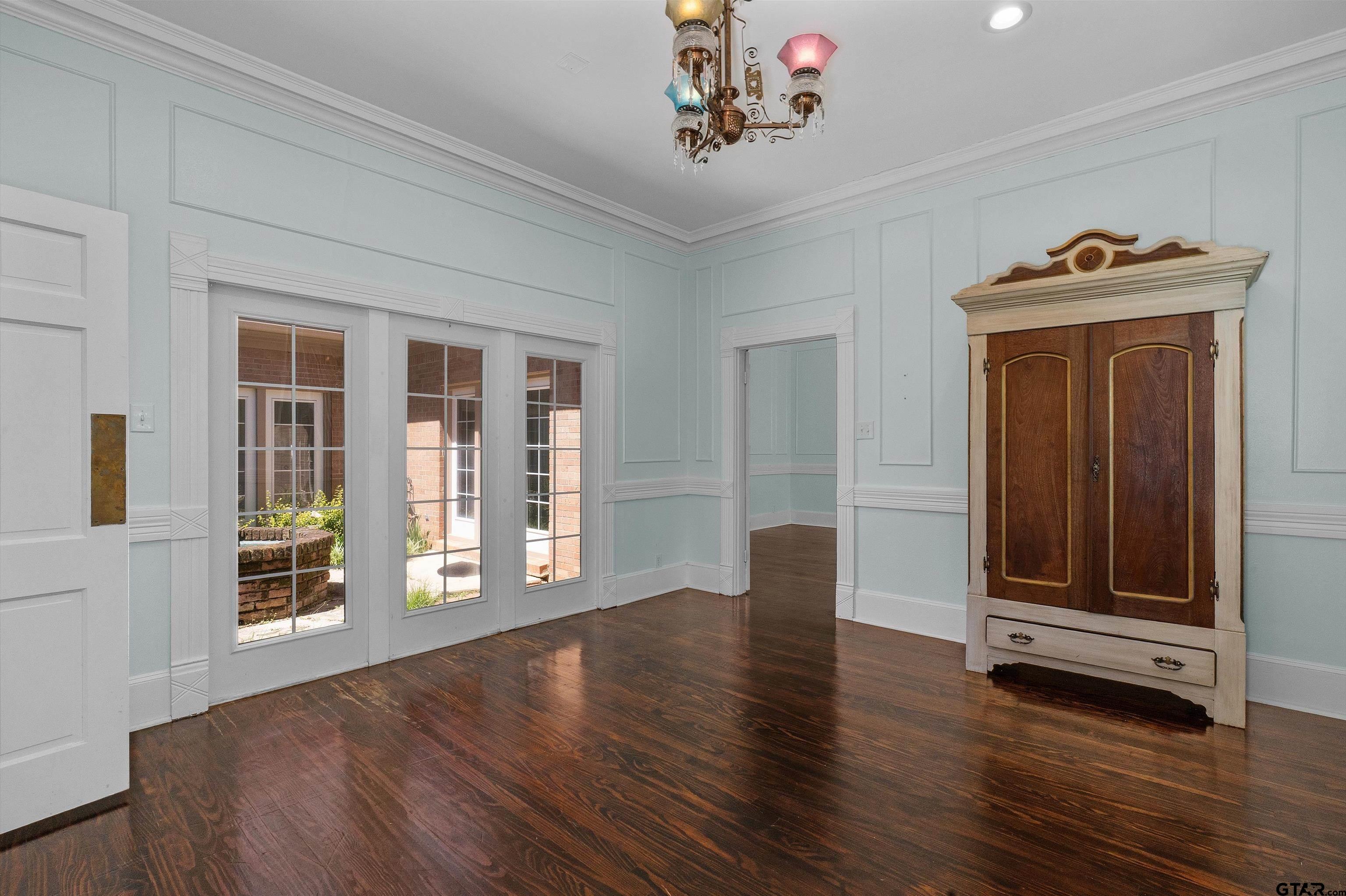 326 East Main Street Henderson, TX 75652 - Photo 11 of 35 a view of an empty room with wooden floor and a window