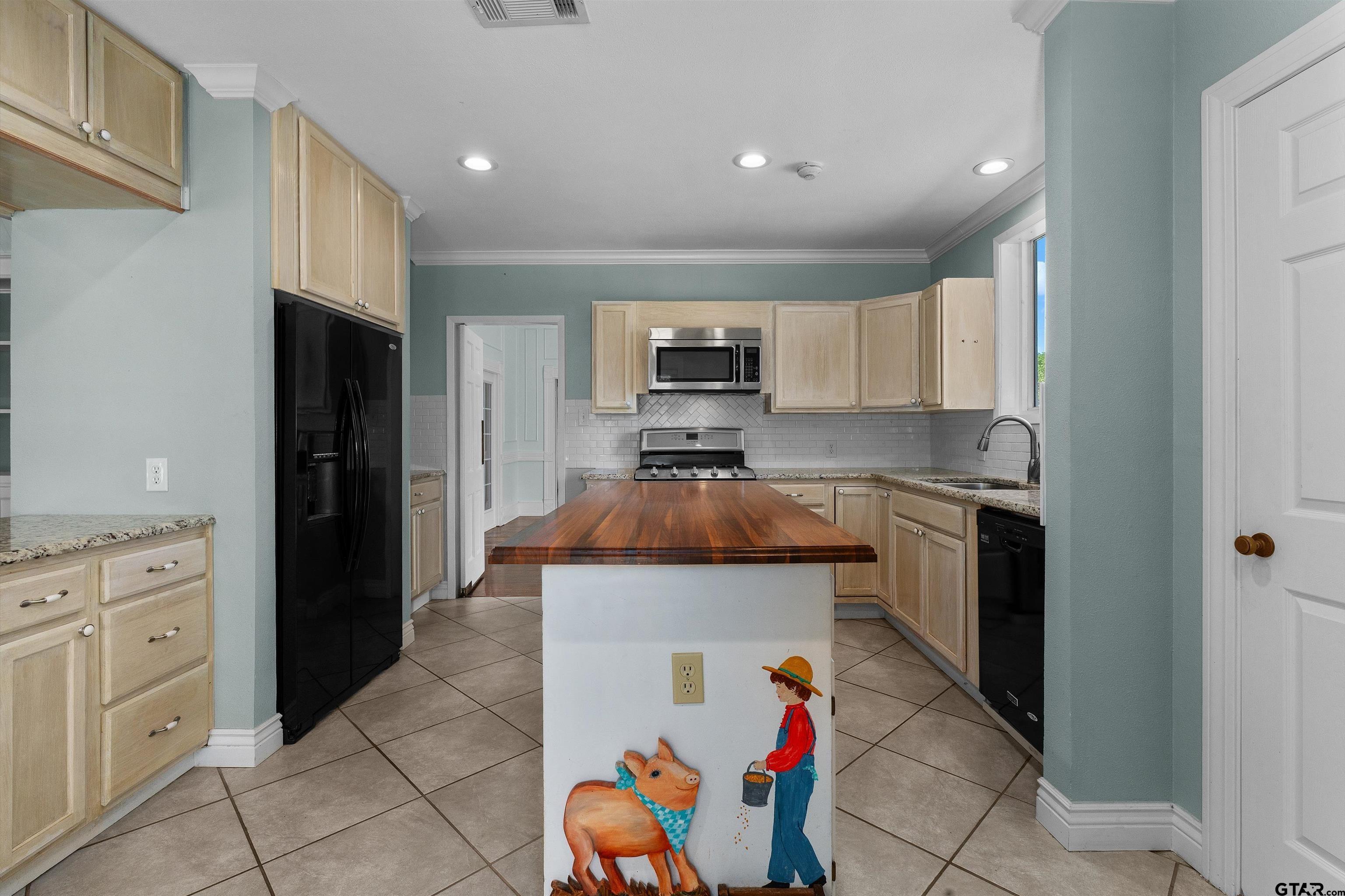 326 East Main Street Henderson, TX 75652 - Photo 12 of 35 a kitchen with a refrigerator and a stove top oven