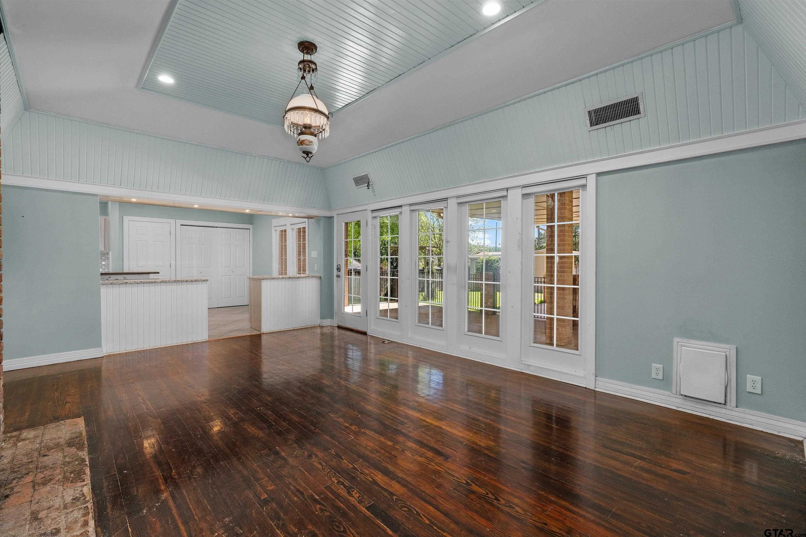 326 East Main Street Henderson, TX 75652 - Photo 16 of 35 a view of an empty room with wooden floor and a window