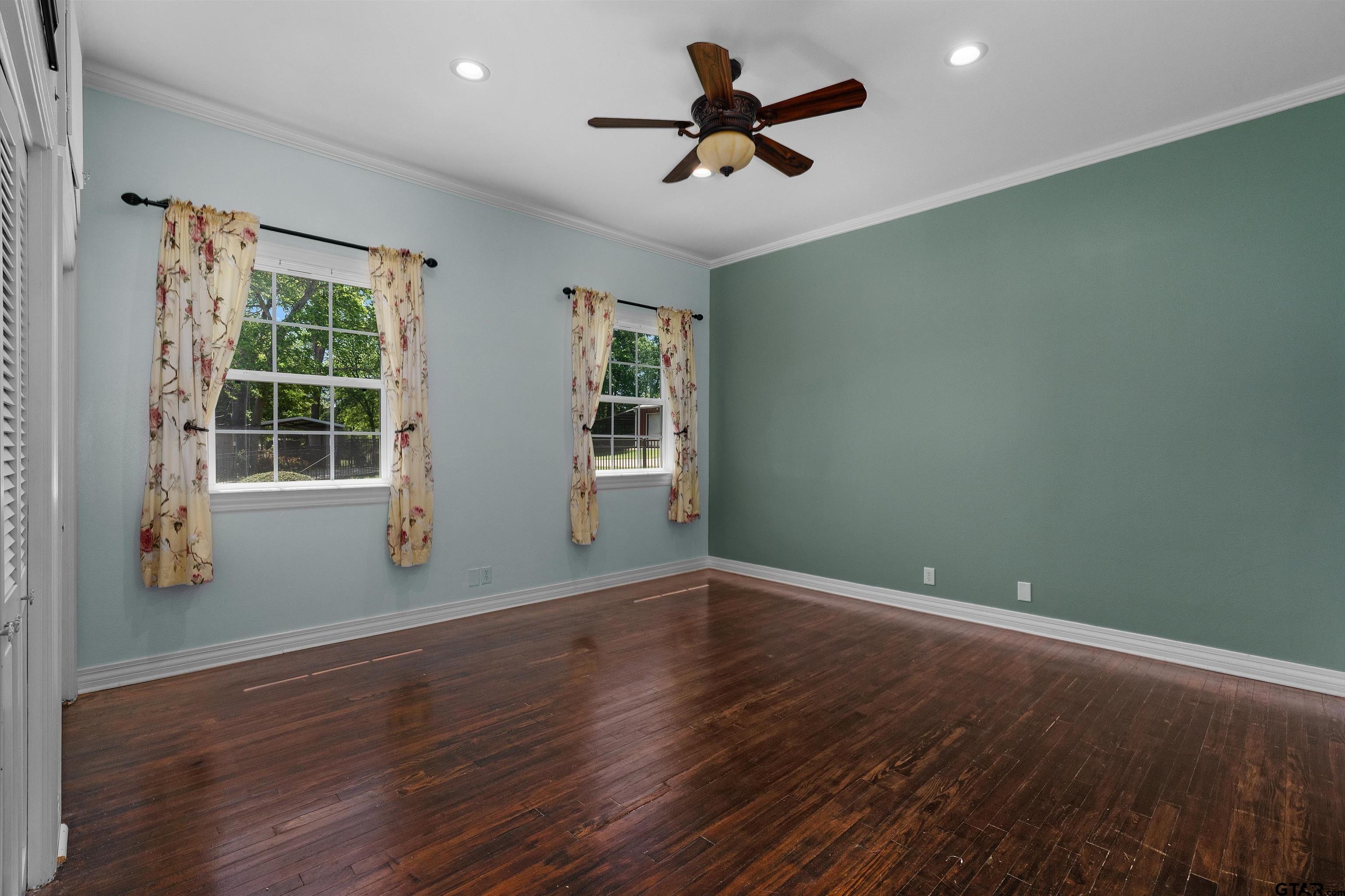 326 East Main Street Henderson, TX 75652 - Photo 18 of 35 a view of empty room with wooden floor and fan