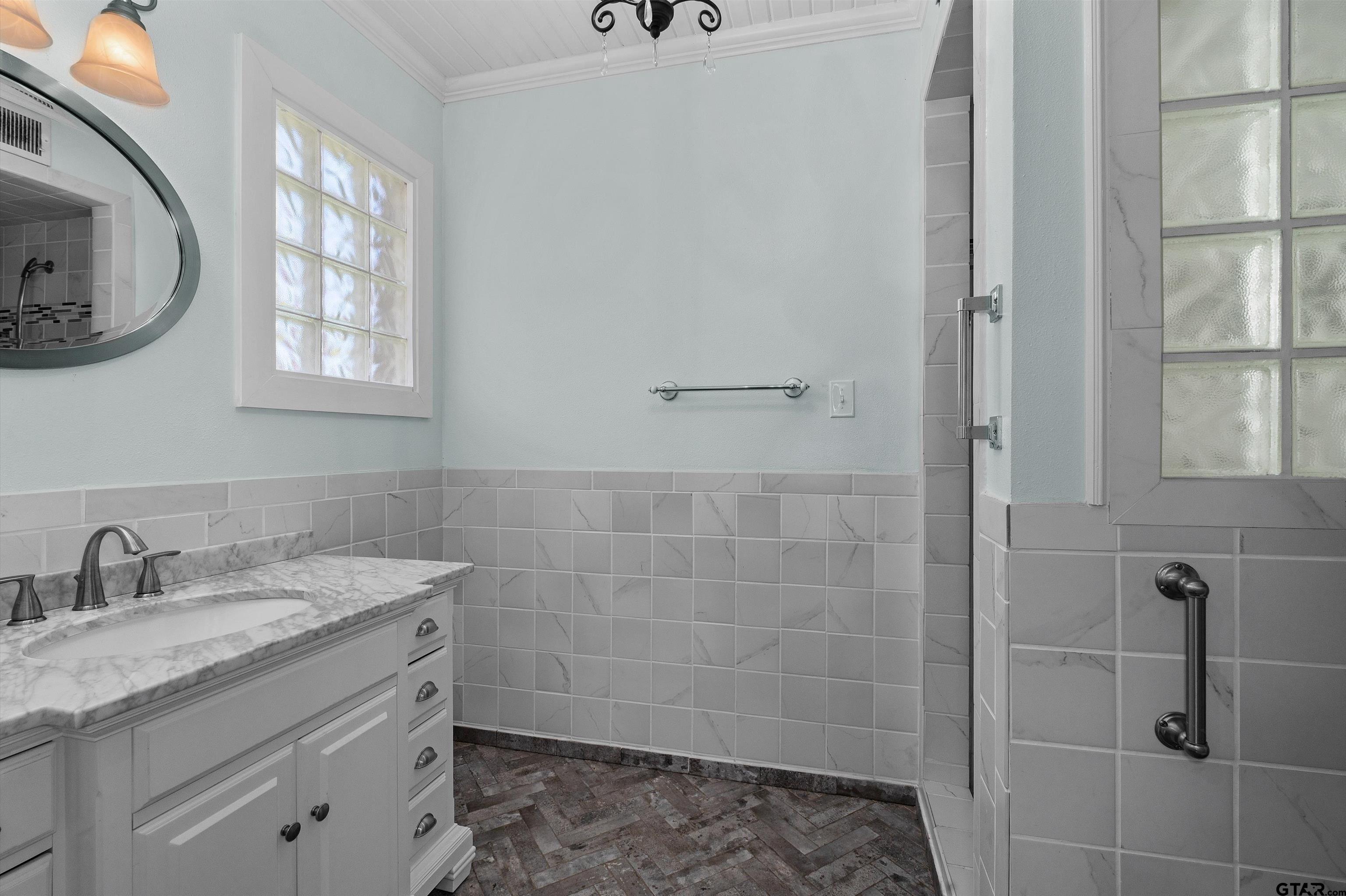 326 East Main Street Henderson, TX 75652 - Photo 20 of 35 a bathroom with a granite countertop sink a mirror and a shower