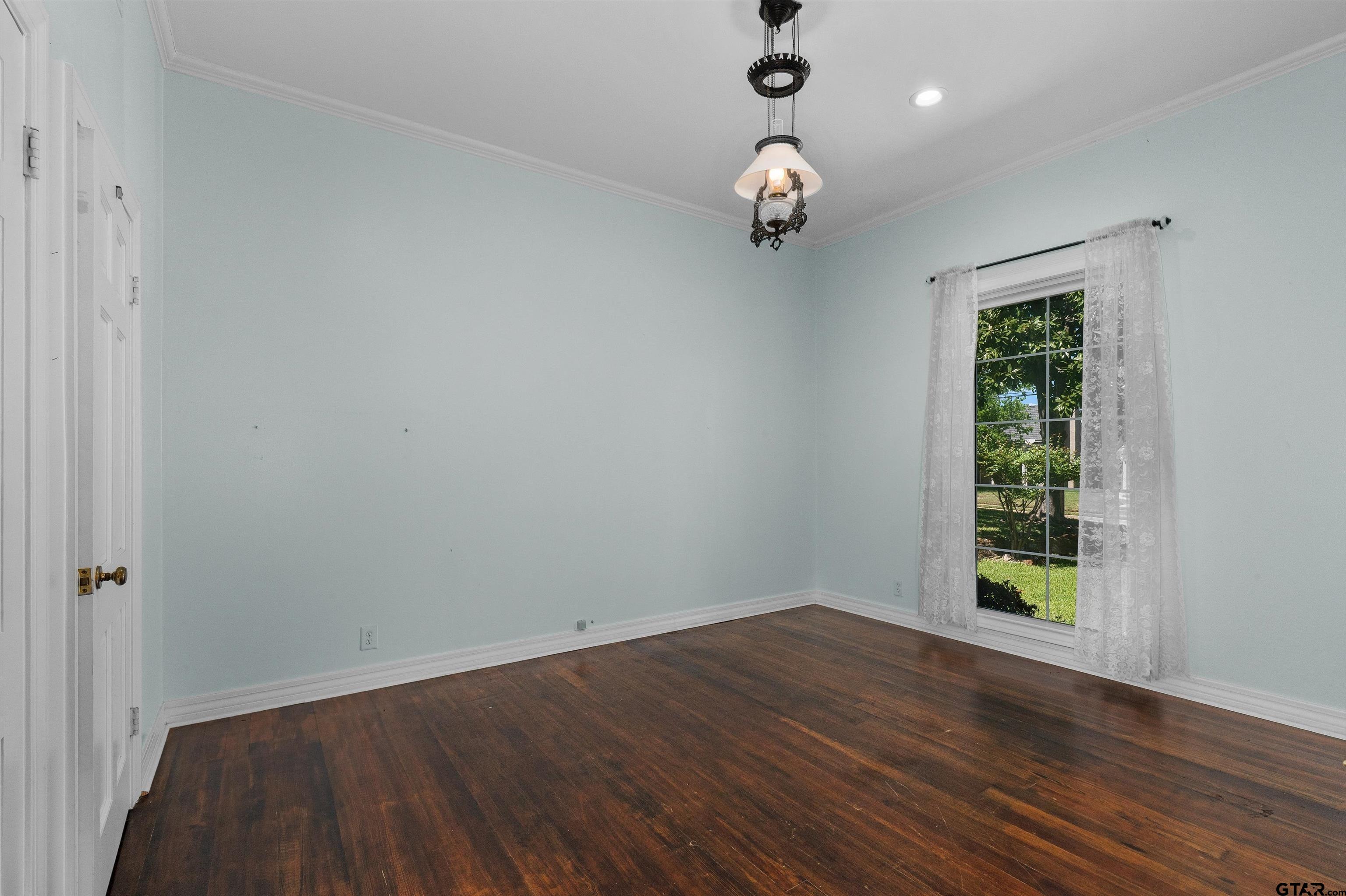326 East Main Street Henderson, TX 75652 - Photo 24 of 35 an empty room with wooden floor and windows