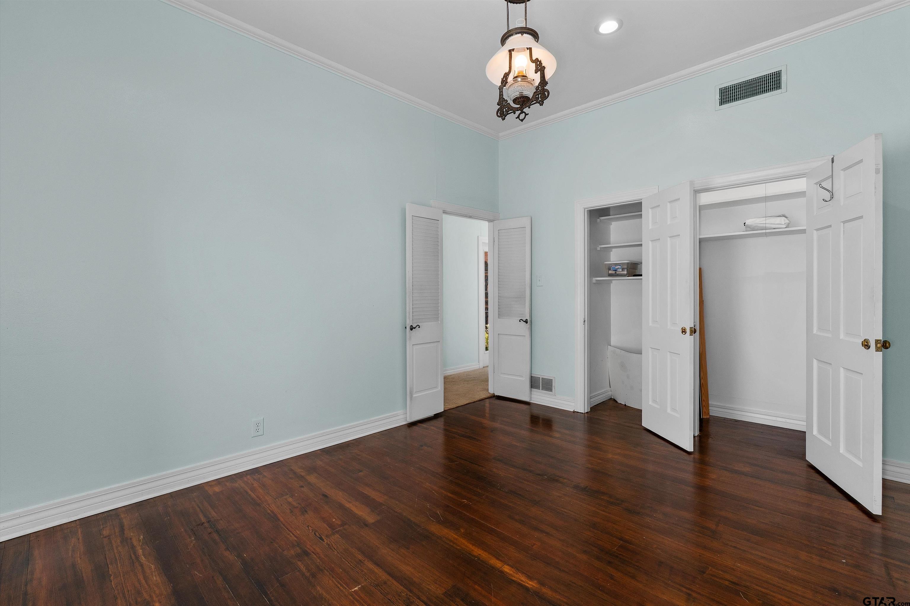 326 East Main Street Henderson, TX 75652 - Photo 25 of 35 an empty room with wooden floor and a ceiling fan
