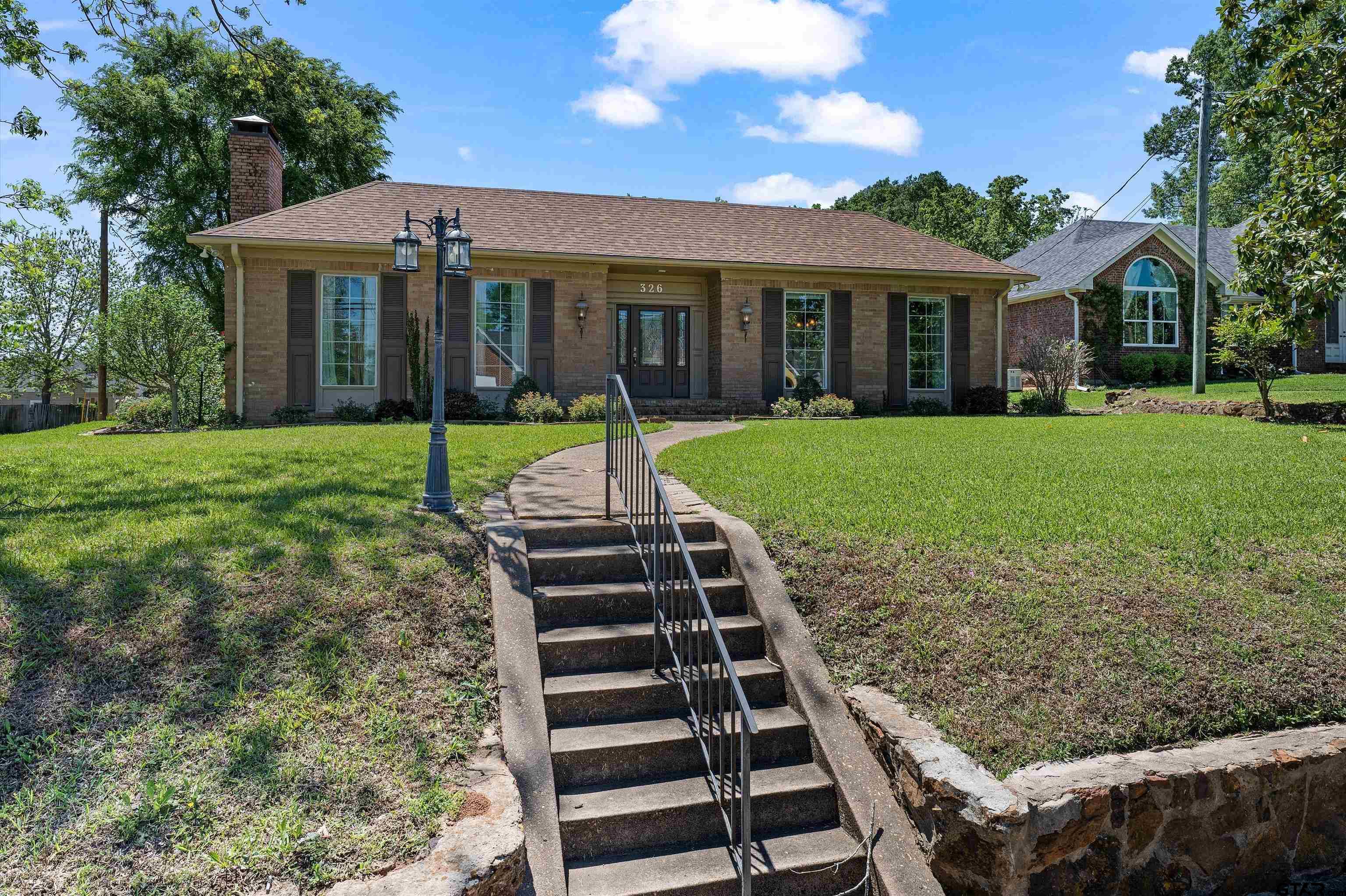 326 East Main Street Henderson, TX 75652 - Photo 4 of 35 a front view of a house with a yard