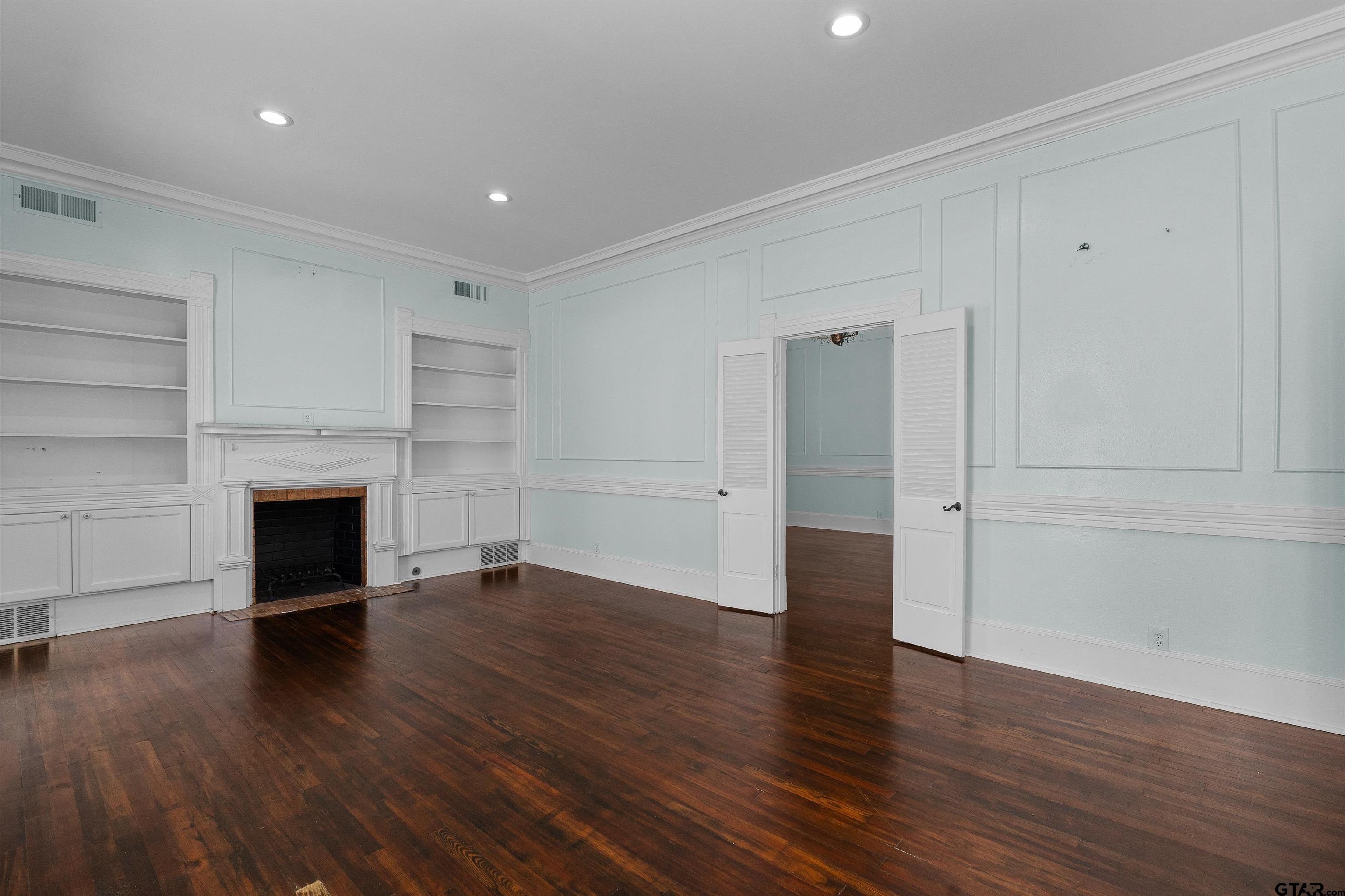 326 East Main Street Henderson, TX 75652 - Photo 8 of 35 wooden floor in an empty room with a fireplace