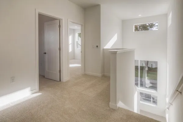 an empty room with windows and closet