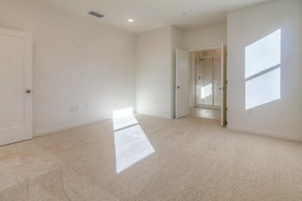 an empty room with windows and closet