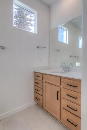 a bathroom with a sink vanity and mirror