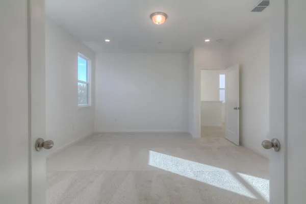 an empty room with windows and closet