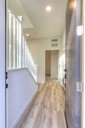 a view of a hallway view with wooden floor and staircase