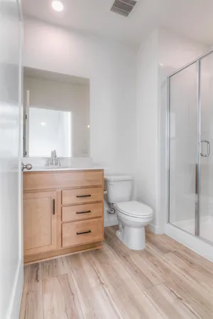 a bathroom with a toilet a sink and a mirror
