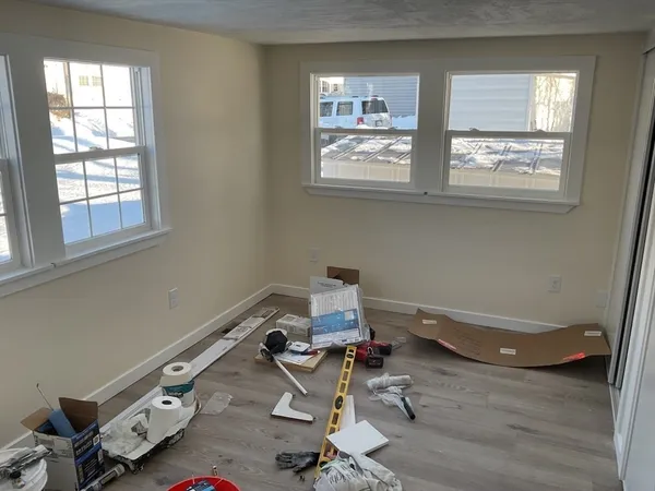 a room with a wooden floor and a window