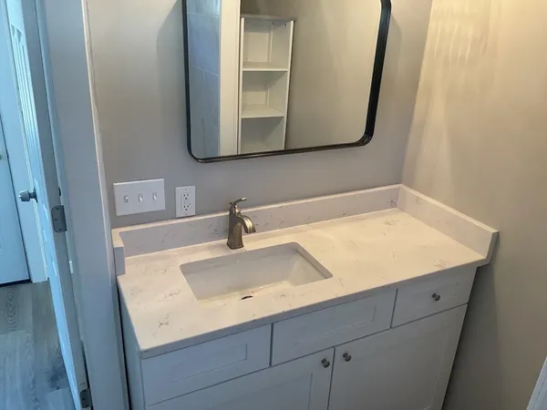 a bathroom with a sink and a mirror