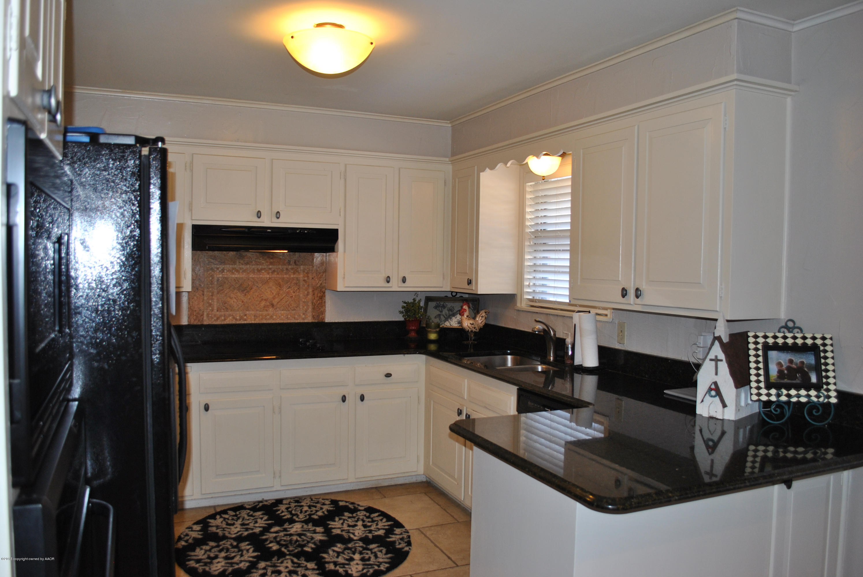 6604 Dreyfuss Road Amarillo, TX 79106 - Photo 8 of 31 a kitchen with granite countertop a sink a stove and cabinets