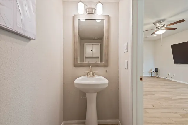 a bathroom with a sink a mirror and vanity