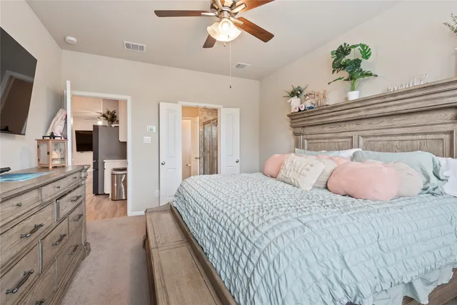 a bedroom with a large bed and a chandelier