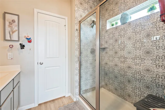 a bathroom with a shower and a sink