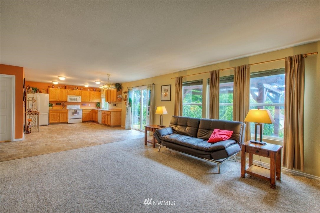 24425 101st Place Southeast Kent, WA 98030 - Photo 12 of 28 a living room with furniture and a large window