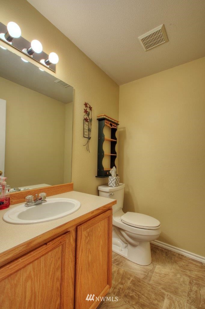 24425 101st Place Southeast Kent, WA 98030 - Photo 14 of 28 a bathroom with a sink a toilet and mirror