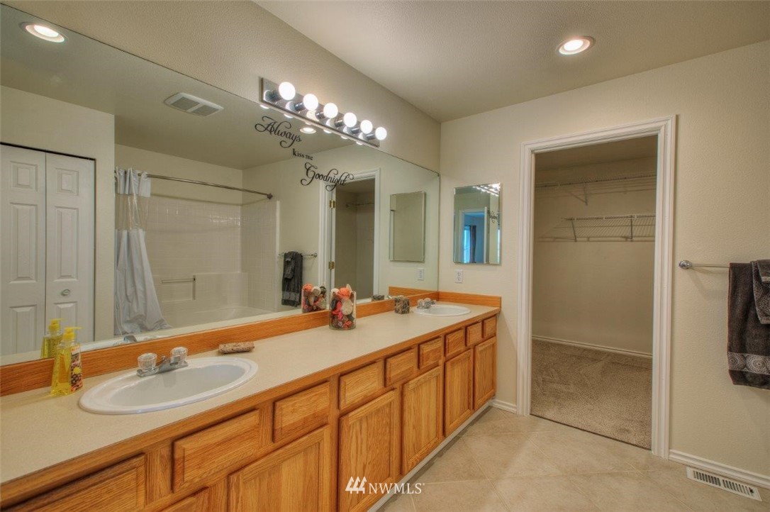 24425 101st Place Southeast Kent, WA 98030 - Photo 16 of 28 a bathroom with a double vanity sink and a mirror