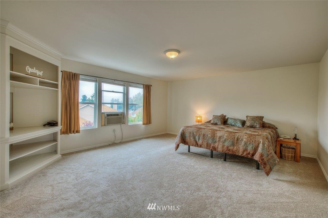 24425 101st Place Southeast Kent, WA 98030 - Photo 17 of 28 a spacious bedroom with a bed and a night stand