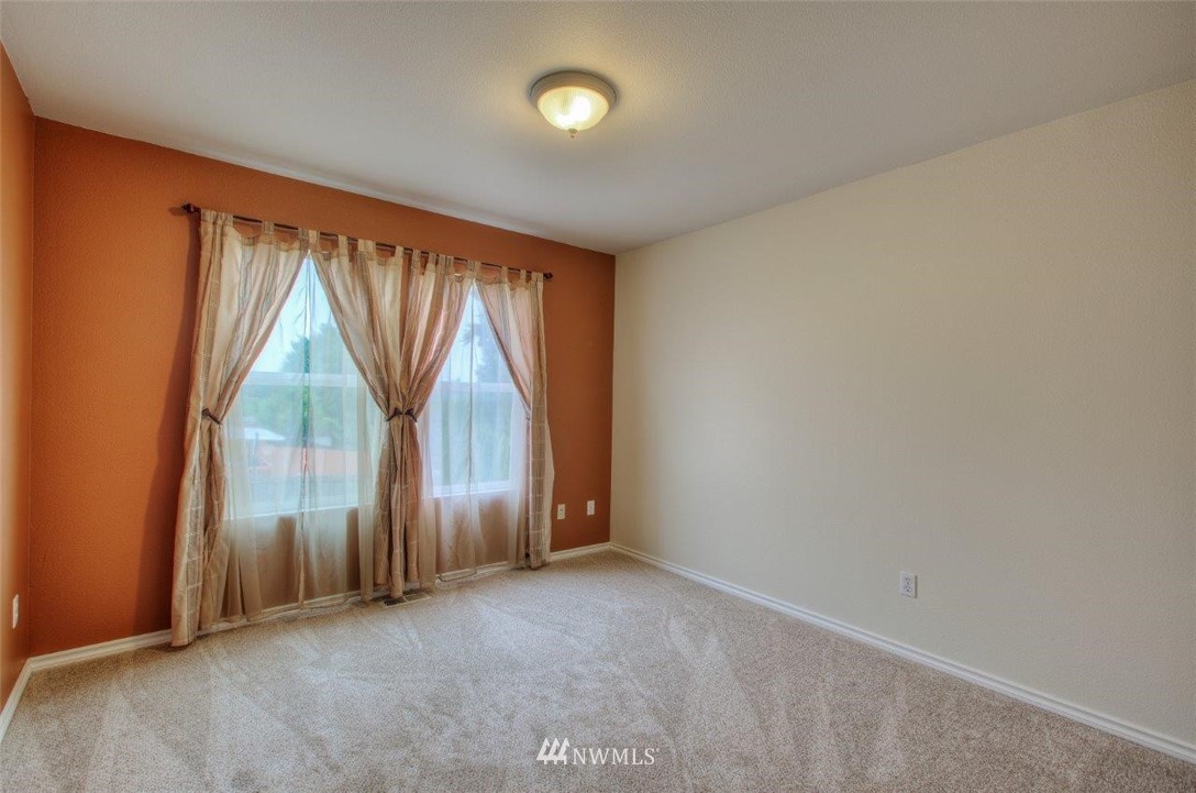 24425 101st Place Southeast Kent, WA 98030 - Photo 18 of 28 an empty room with windows and entrance