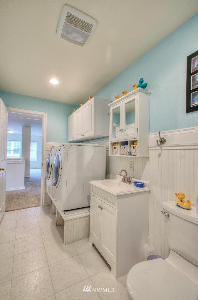 24425 101st Place Southeast Kent, WA 98030 - Photo 23 of 28 a white refrigerator freezer sitting inside of a kitchen