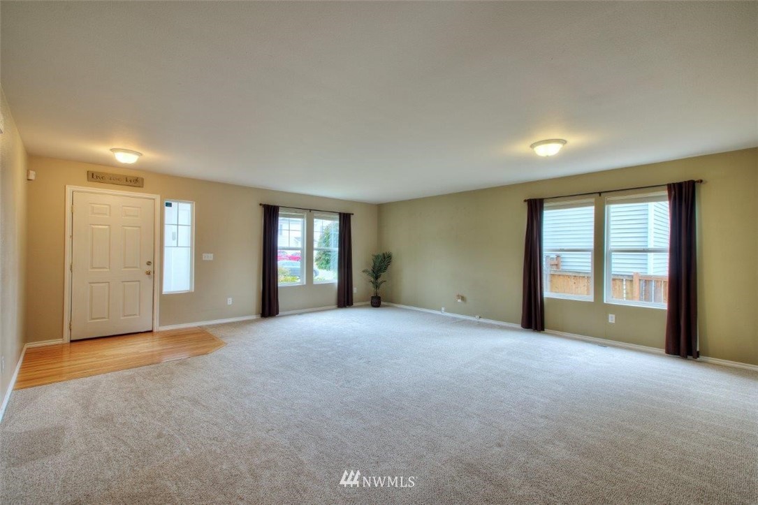 24425 101st Place Southeast Kent, WA 98030 - Photo 5 of 28 a view of an empty room with window and wooden floor