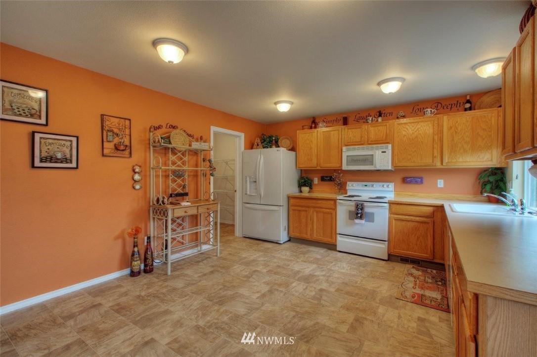 24425 101st Place Southeast Kent, WA 98030 - Photo 7 of 28 a kitchen with refrigerator and cabinets