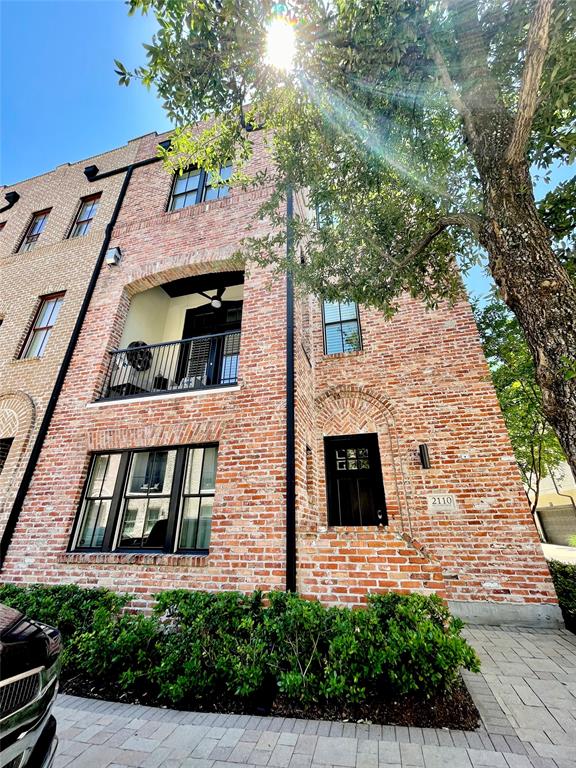 a front view of a house with plants