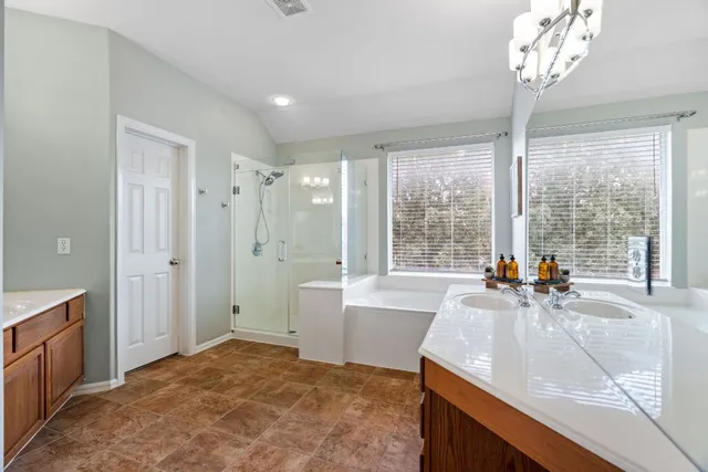 a view of a bathroom with dual sinks